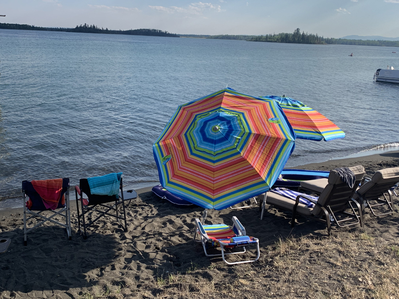 Colourful beach umbrellas on the shoreline.